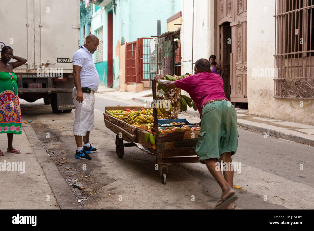 Un homme poussant un panier de fruits dans la rue à La Havane, Cuba. Banque D'Images