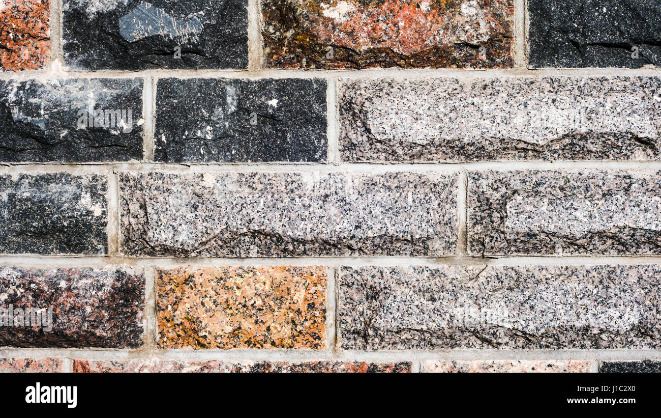 Seamless texture, l'arrière-plan, bordée de murs en pierres de granit. grès. stone mur à l'arrière-plan. Pierre Banque D'Images
