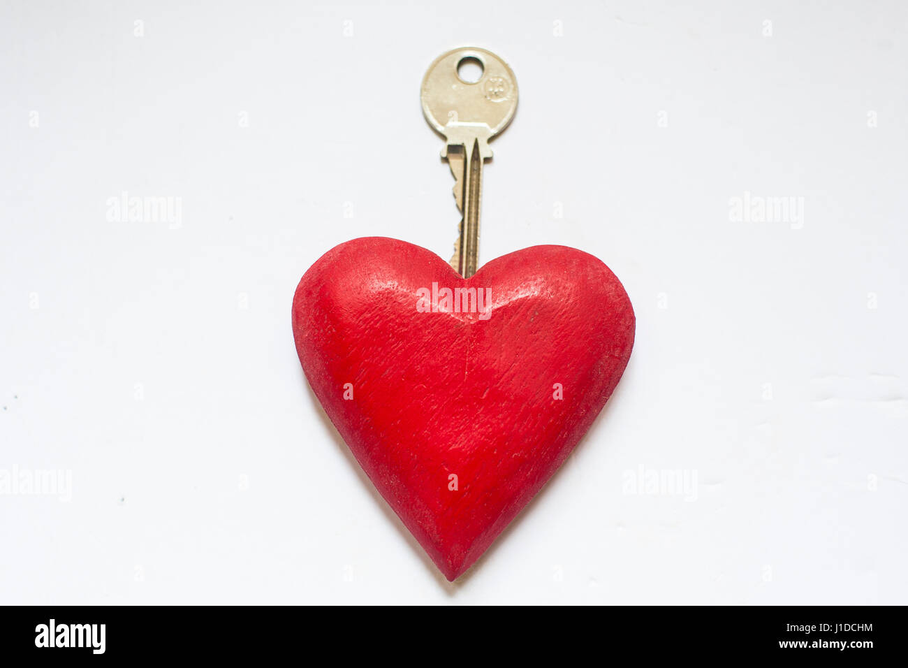 Touche et cœur rouge. La clé de votre coeur Banque D'Images