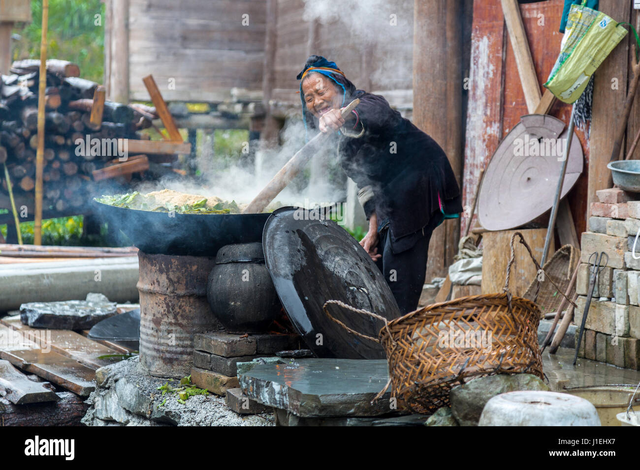 Huanggang, Guizhou, en Chine. Les femmes Dong pour la cuisson des aliments Porcs verts. Banque D'Images