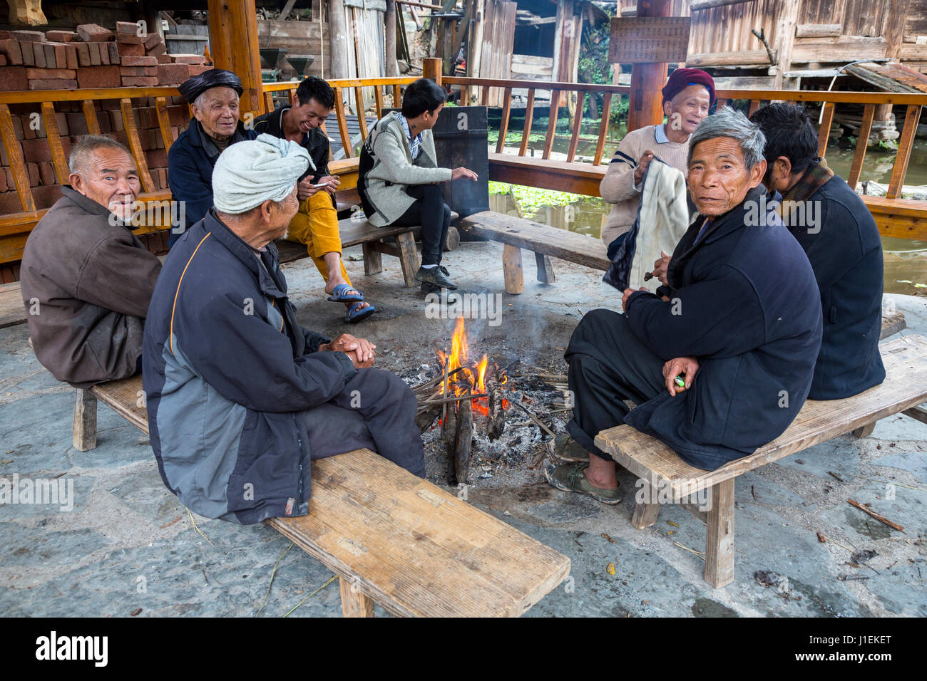 Huanggang, Guizhou, en Chine. Les hommes du village Réunion dans une tour du tambour d'un village ethnique Dong. Banque D'Images