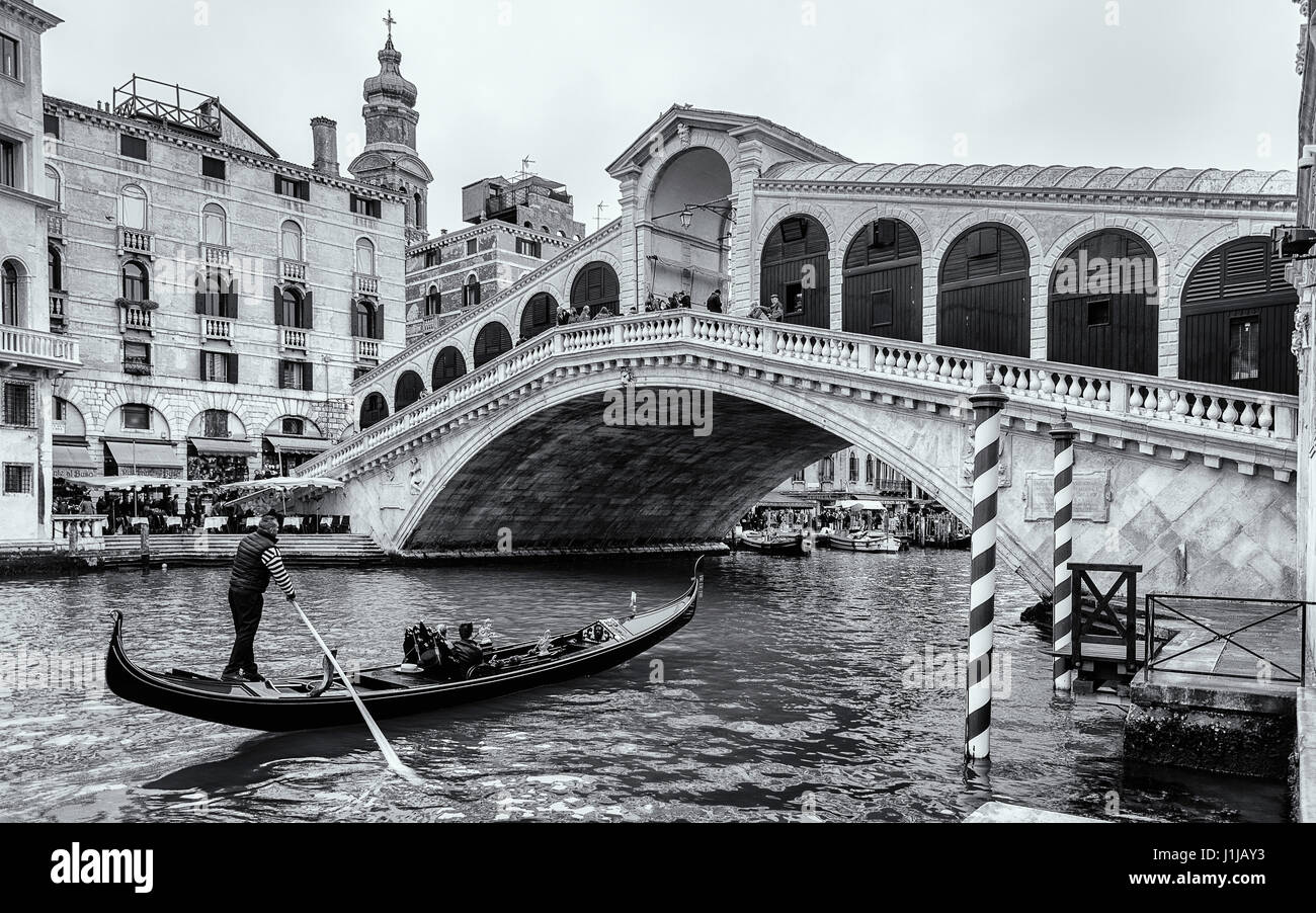 Image en noir et blanc du Grand Canal avec un gondolier approche du pont du Rialto (Ponte di Rialto), Venise Italie Banque D'Images