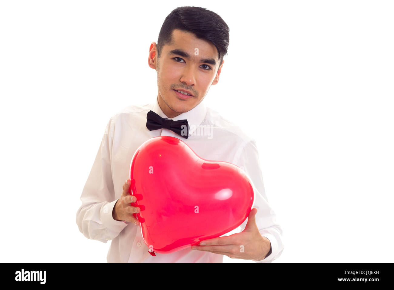 Jeune homme avec Bow-tie holding balloon Banque D'Images