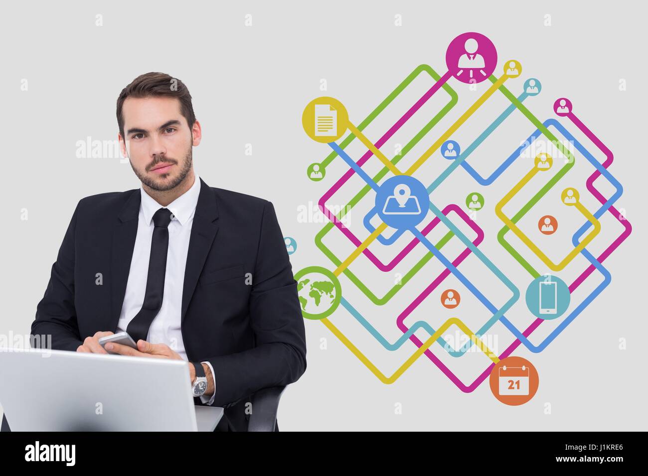 Digital composite de Portrait of businessman using laptop avec des icônes en arrière-plan Banque D'Images