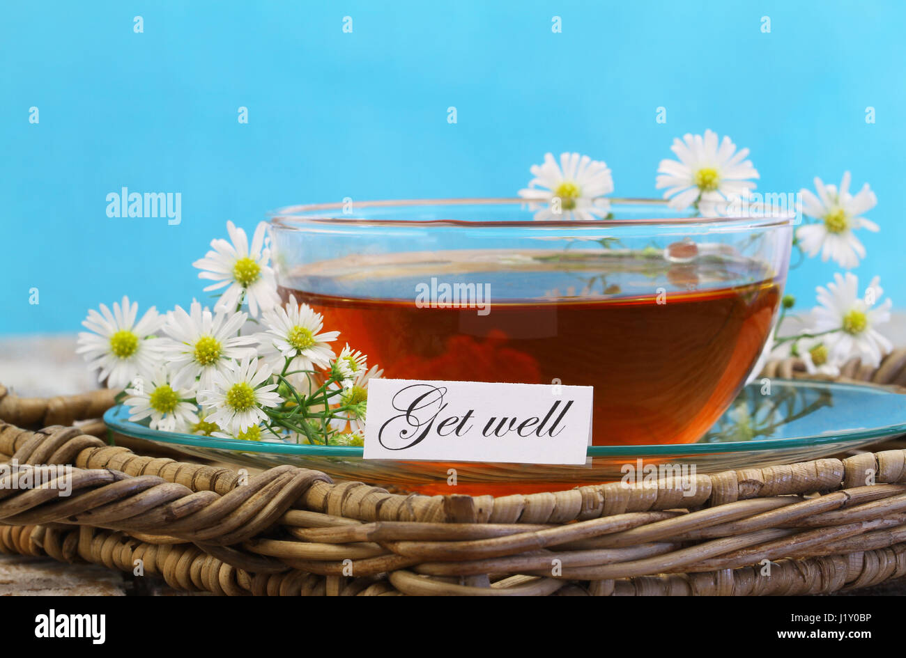 Carte de prompt avec tasse de thé et camomille fleurs sur fond bleu Banque D'Images