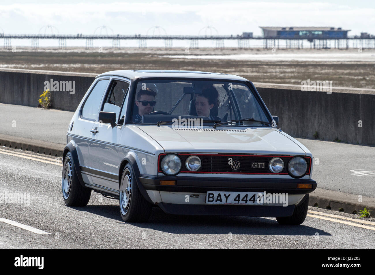 Golf GTI au Vintage Festival et Classic Vehicle Show, avec des voitures roulant sur le front de mer et de villégiature, Southport, Merseyside, Royaume-Uni Banque D'Images