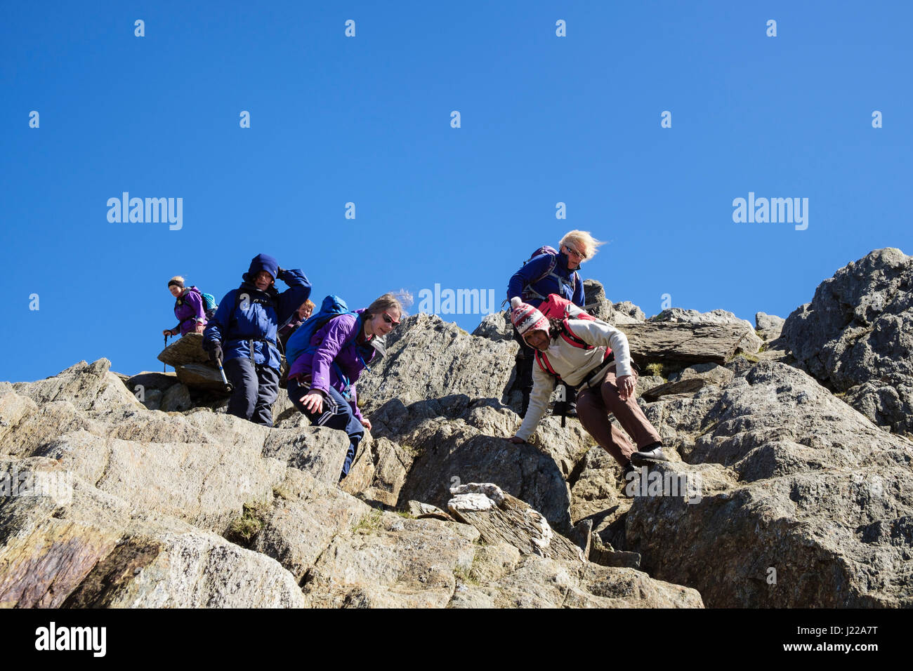 Regardant vers le bas sur les rochers, les randonneurs scrambling sur Lliwedd Y Mountain dans le parc national de Snowdonia. Gwynedd, Pays de Galles, Royaume-Uni, Angleterre Banque D'Images