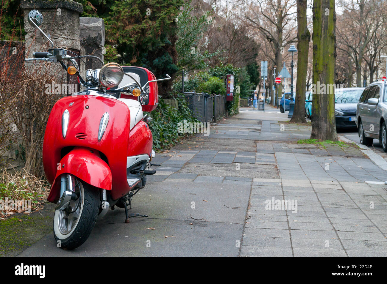 Moto vintage rouge garée sur le trottoir de la rue Banque D'Images