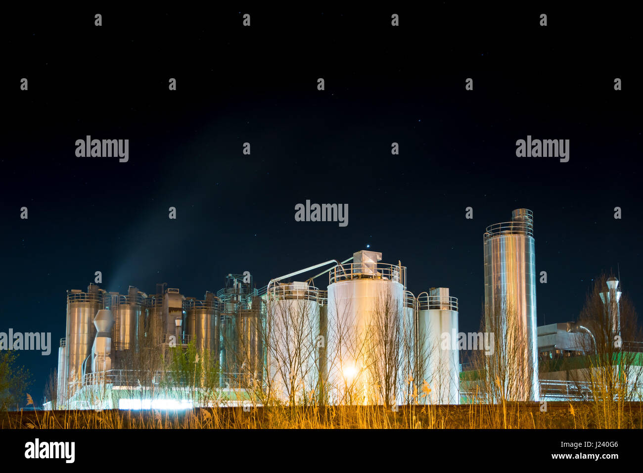 Allumé en réservoirs de stockage d'une usine chimique dans la nuit Banque D'Images