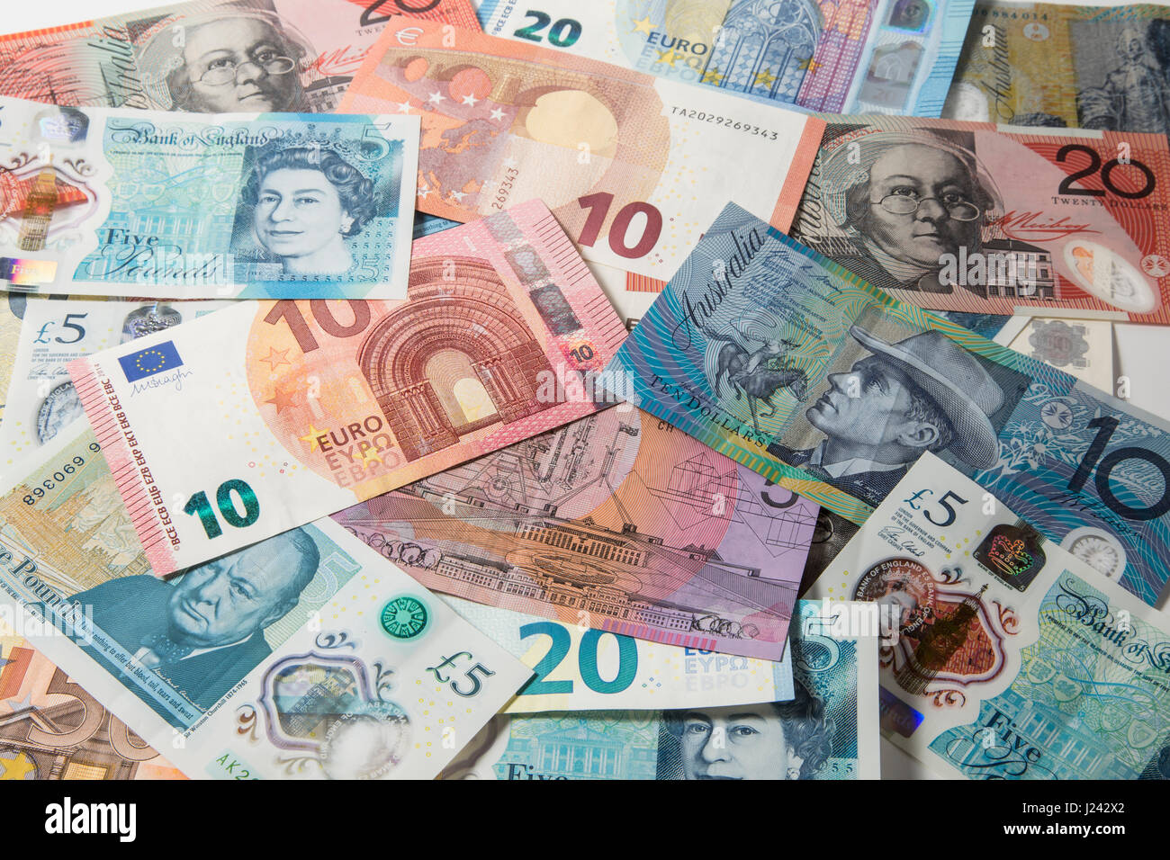 New British £1 et £2 pièces sur un fond d'Euros et £5 pound note Banque D'Images