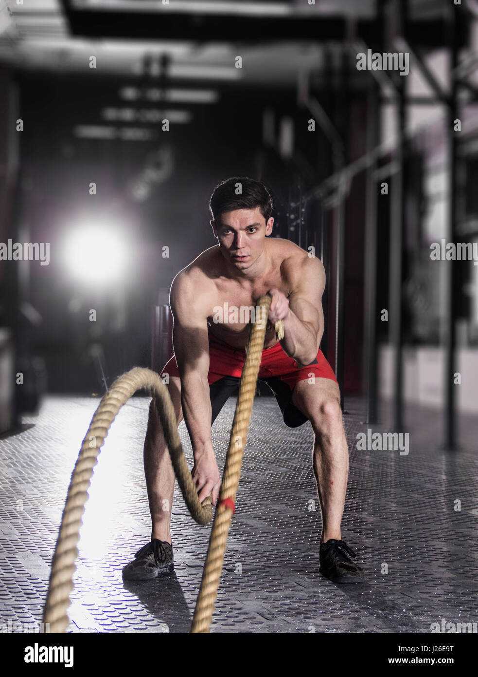 Athlète musclé avec corde bataille bataille des cordes de l'exercice dans la f Banque D'Images