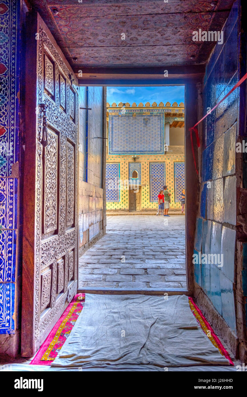 Vue de la vieille ville de Khiva rue grâce à la porte en bois sculpté, l'Ouzbékistan Banque D'Images