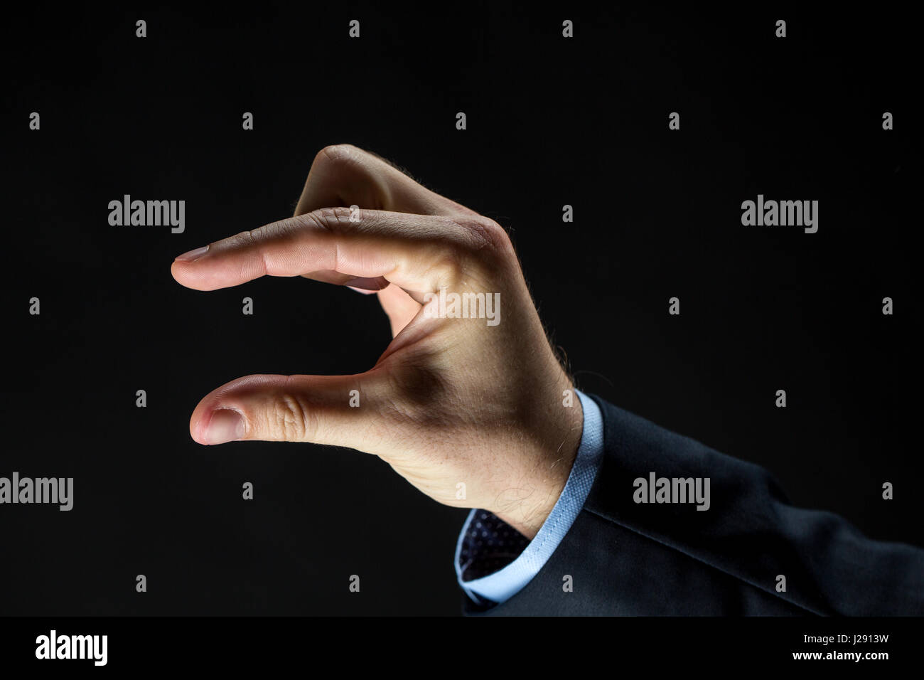 Close up of businessman part montrant petite taille Banque D'Images