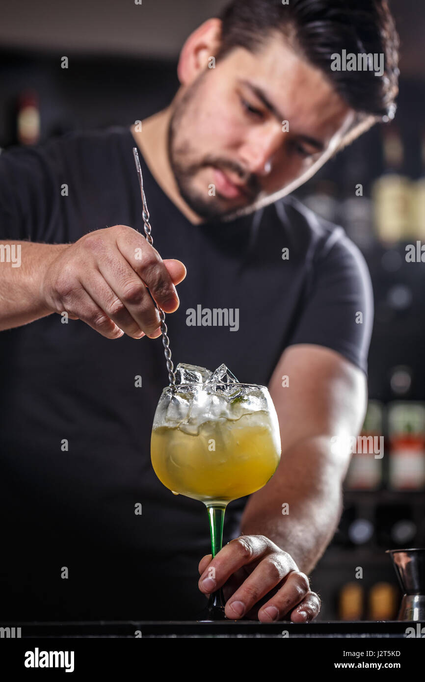 Barman est en remuant des cocktails sur comptoir bar Banque D'Images