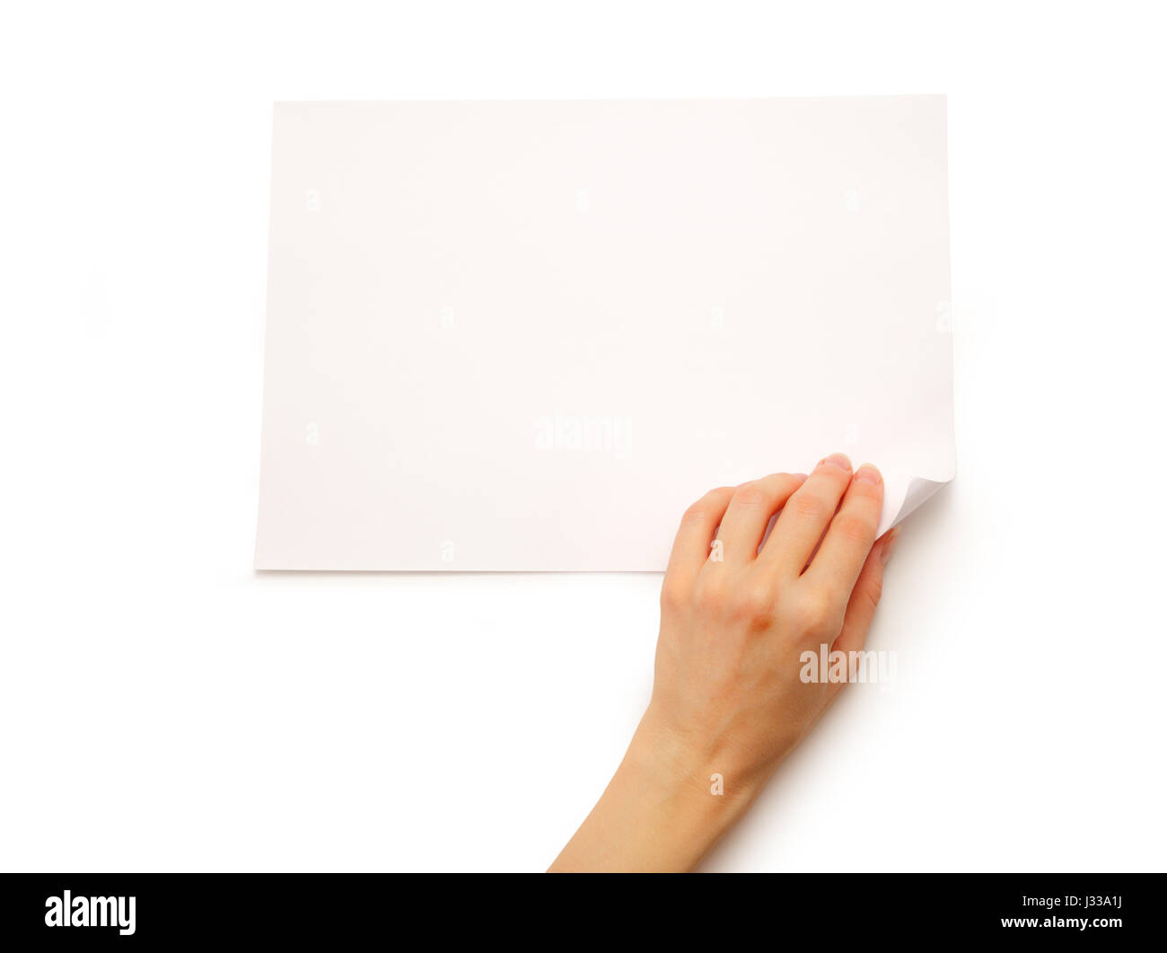 La main de femme tournant sur feuille de papier Banque D'Images