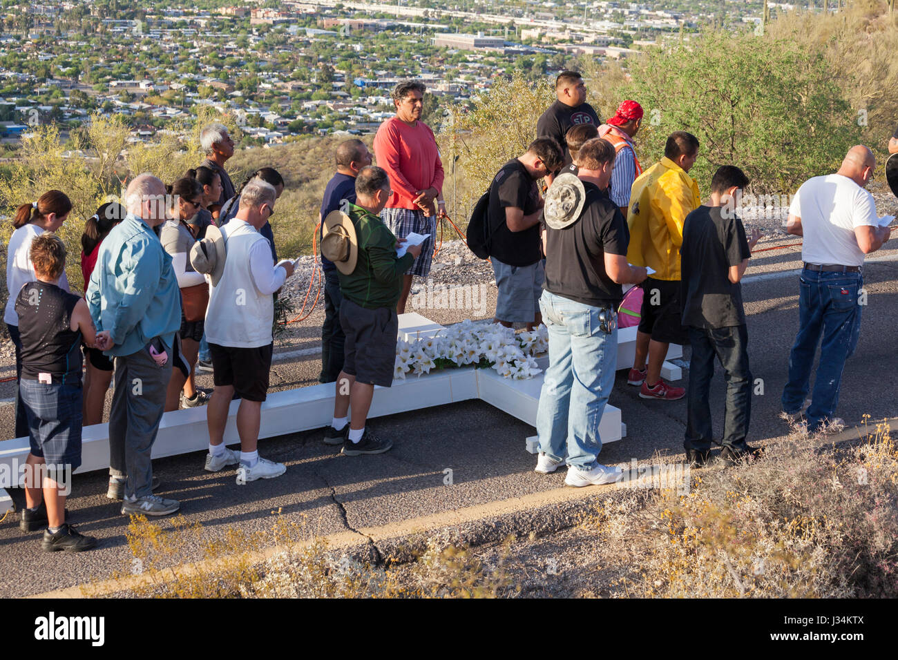 Tucson, Arizona - Les participants à une procession annuelle bon vendredi portent une grande croix de montagne sentinelle. La procession s'arrête pour les stations de la Banque D'Images