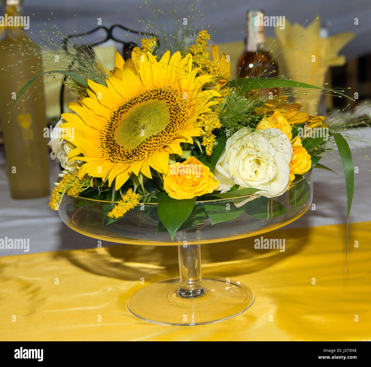 Décoration de masse avec des fleurs. Un bouquet de roses blanches et jaunes, de tournesols et de plantes sauvages Banque D'Images