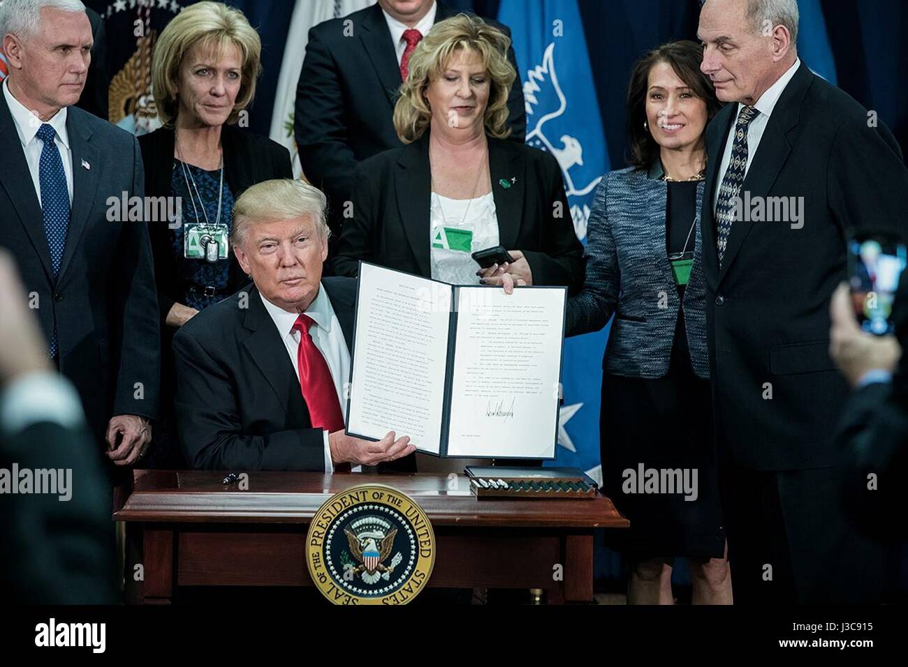 Le Président américain Donald Trump contient jusqu'a signé le décret accroître la sécurité frontalière et l'immigration au ministère de la sécurité intérieure, 25 janvier 2017 à Washington, D.C. Vice-président Mike Pence est à gauche et le secrétaire à la sécurité intérieure, John Kelly le droit. Banque D'Images