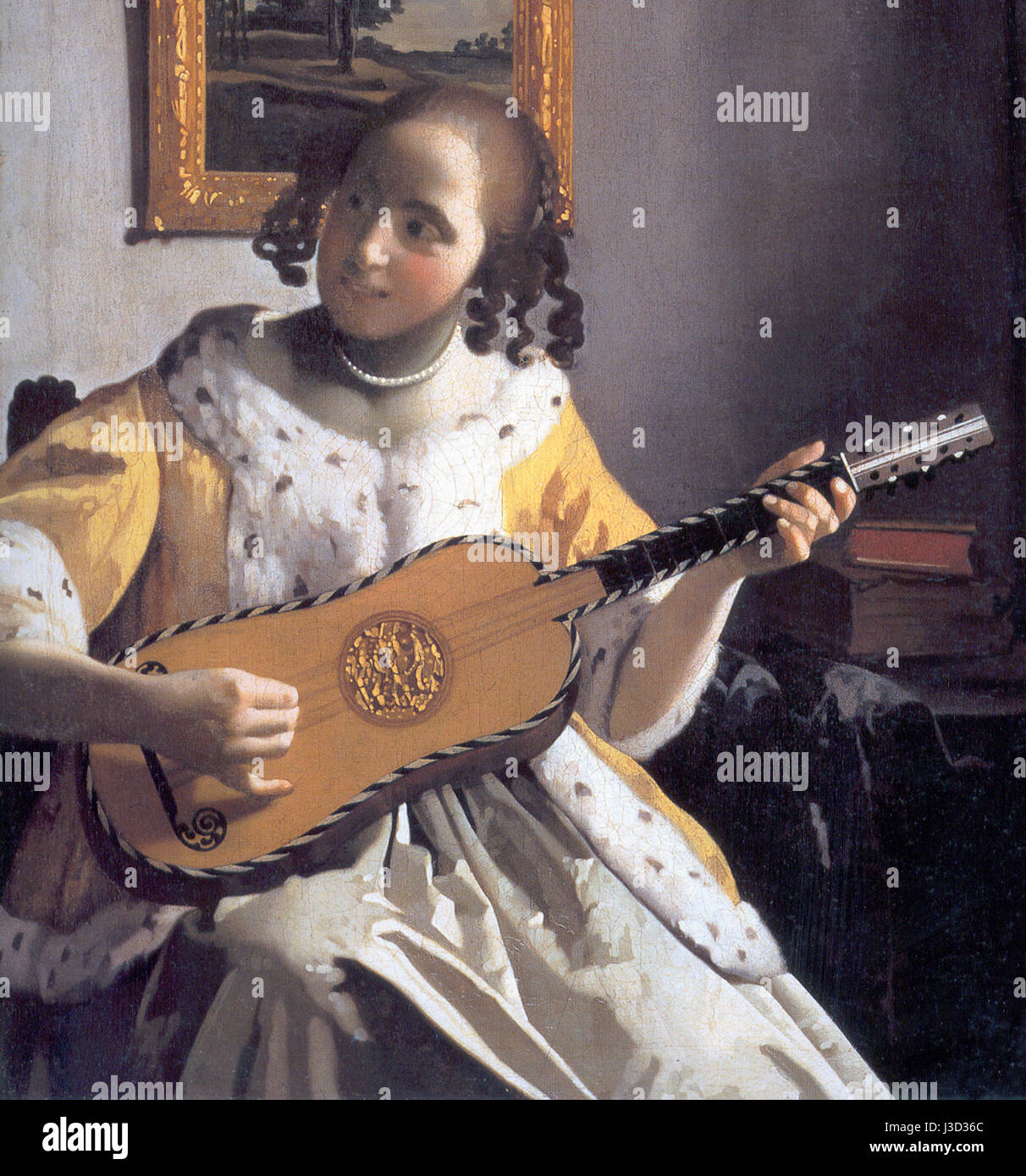 'Detalle de la guitarrista de Vermeer' fait référence à une vue détaillée de la peinture 'le joueur de guitare' de Johannes Vermeer, mettant en évidence la représentation complexe de la musicienne et de son instrument. L'œuvre illustre l'utilisation de la lumière et de l'ombre par Vermeer dans la capture des moments de tous les jours. Banque D'Images