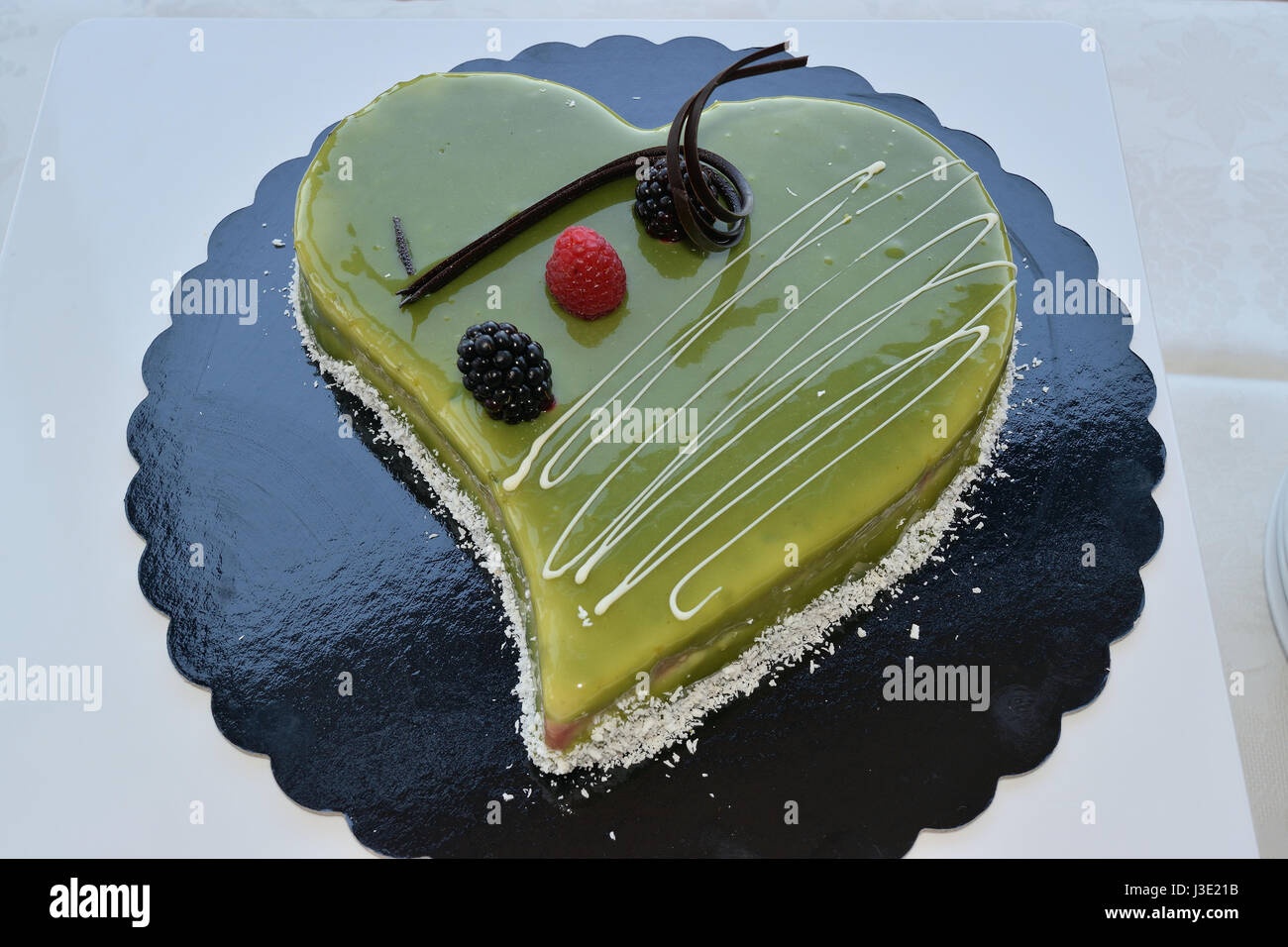 Gâteau en forme de coeur garnie de crème de pistache Banque D'Images