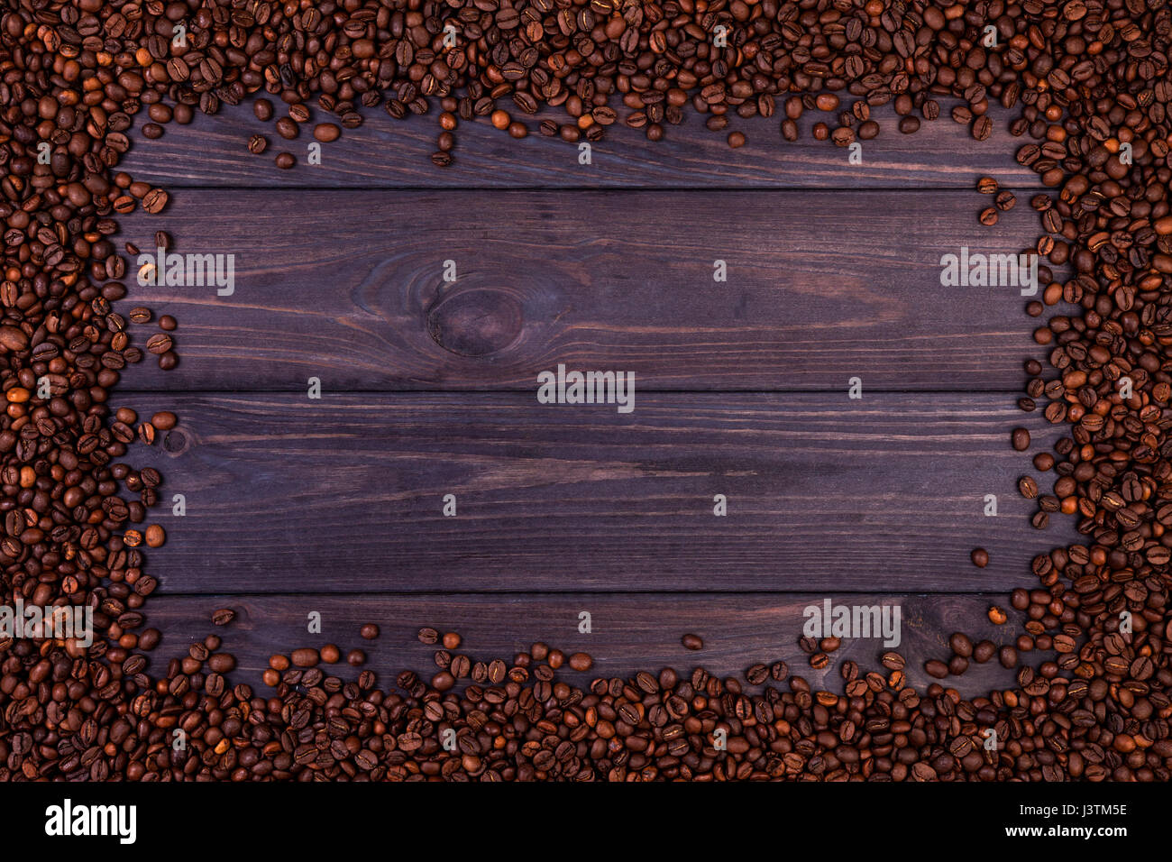 Frame de grains de café sur fond de bois sombre. Top View with copy space Banque D'Images