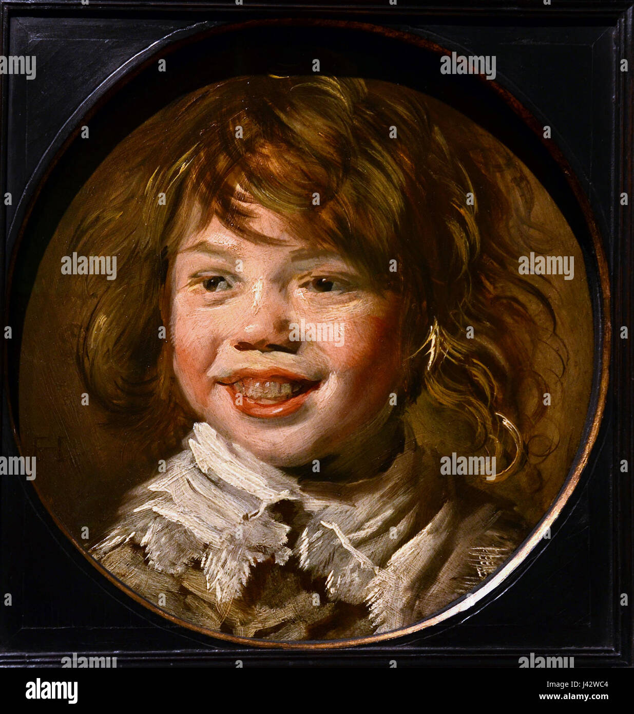 Le tableau 'Lachende jongen' (garçon riant) de Frans Hals est une œuvre d'art remarquable du XVIIe siècle, conservée dans la Mauritshuis à la Haye, aux pays-Bas. Le portrait capture l'expression vivante et le caractère de son sujet. Banque D'Images