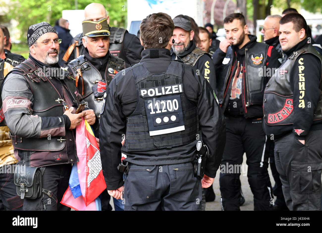 Berlin, Allemagne. 9 mai, 2017. Un policier parle aux membres de la Fédération de moto club "Les loups" nuit sur le terrain de la guerre soviétique dans le quartier de Treptow à Berlin, Allemagne, le 9 mai 2017. Le club se souvient de la fin de la Seconde Guerre mondiale et la victoire sur le fascisme avec gerbe de cérémonie. Le 9 mai est la "Journée de la Victoire" en Russie. Photo : Jens Kalaene Zentralbild-/dpa/dpa/Alamy Live News Banque D'Images