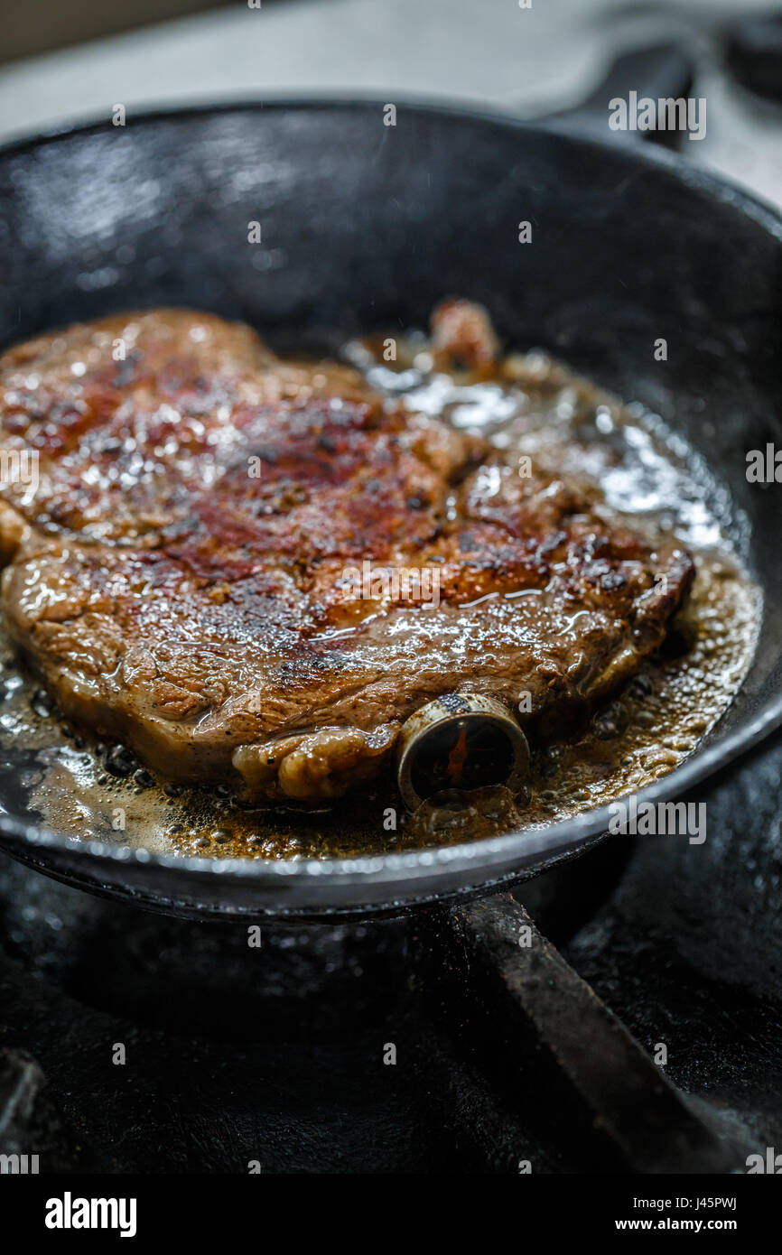 Steak de porc grillé avec thermomètre à viande dans une poêle Banque D'Images