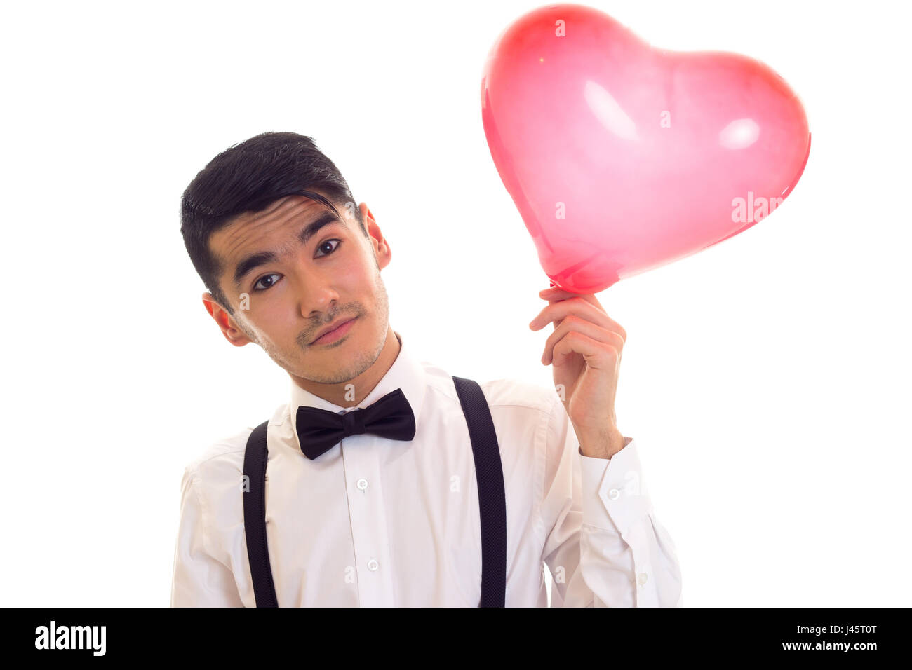 Jeune homme avec Bow-tie holding balloon Banque D'Images