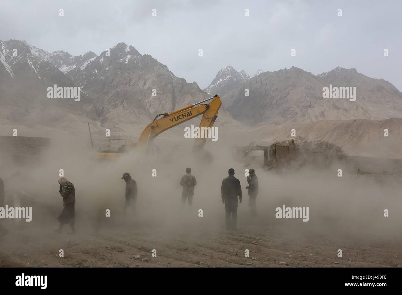 Taxkorgan, la Région Autonome Uygur du Xinjiang. Le 11 mai, 2017. Les sauveteurs de démolir les maisons endommagées afin de prévenir d'autres danger dans Quzgun Village de quake-frapper Taxkorgan, comté du nord-ouest de la Chine La région autonome du Xinjiang Uygur, 11 mai 2017. Huit décès ont été confirmés et 23 blessés après le tremblement de terre en comté de Taxkorgan, Xinjiang, à 5 h 58 jeudi. Elle a également entraîné de graves dommages ou l'effondrement de 1 520 maisons. Crédit : Li Jing/Xinhua/Alamy Live News Banque D'Images