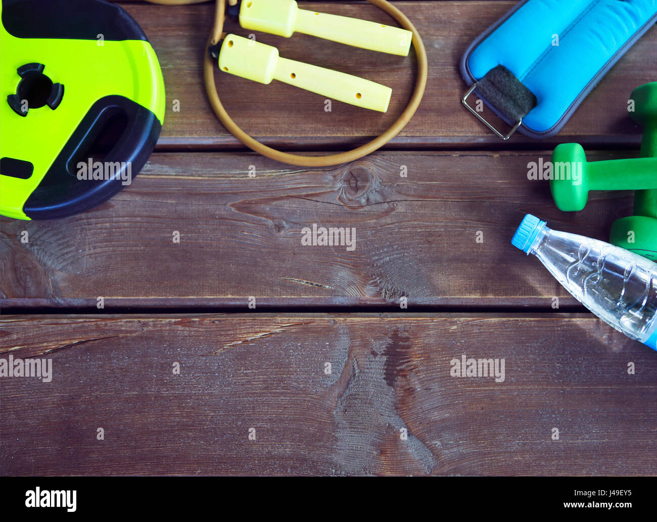 Les équipements de sport et de l'eau pure sur un fond de bois. Des articles de sport sur le fond en bois. Pour les activités sportives dans la salle de sport Banque D'Images