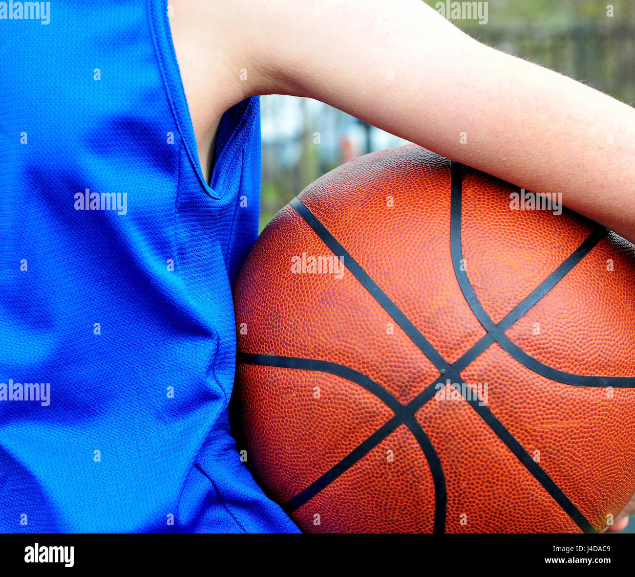 Vue arrière d'un joueur de basket-ball portant des uniformes bleu avec la balle Banque D'Images