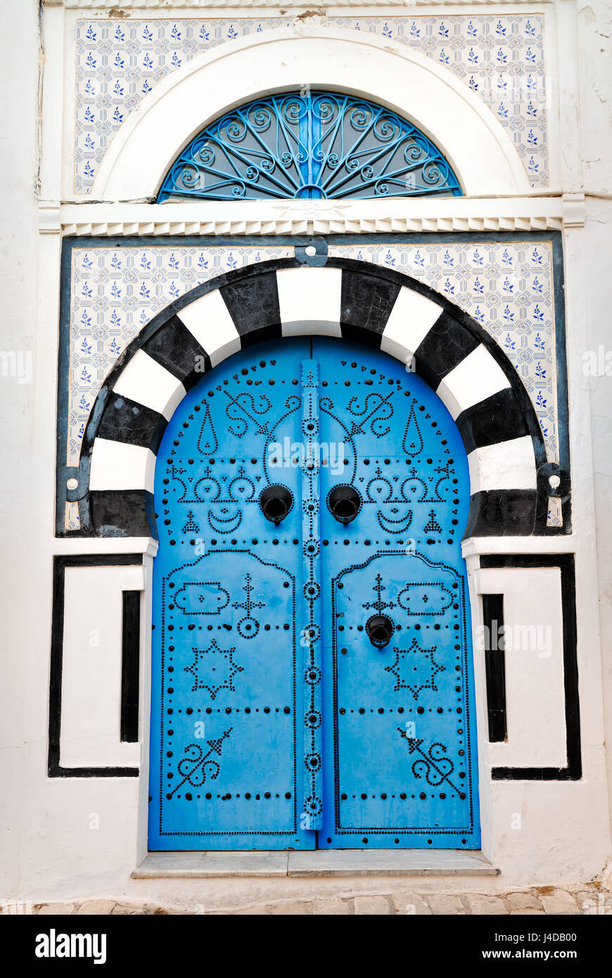 Porte voûtée avec porte cloutée bleu, Afrique, Afrique du Nord, Tunisie, Sidi Bou Said Banque D'Images