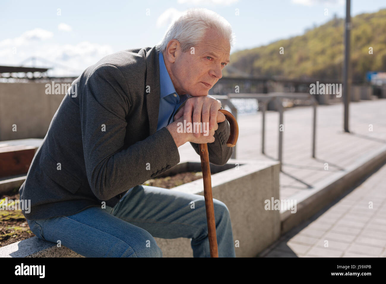 Pensionné isolé observant tout autour de l'extérieur Banque D'Images