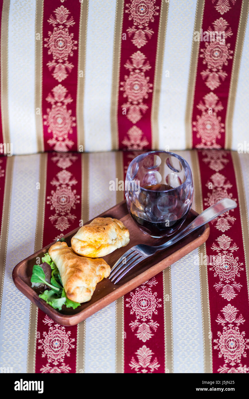 Un style à partir de la Patagonie : Deux empanadas et un verre de vin dans une retraite chic dans le sud du monde. Banque D'Images