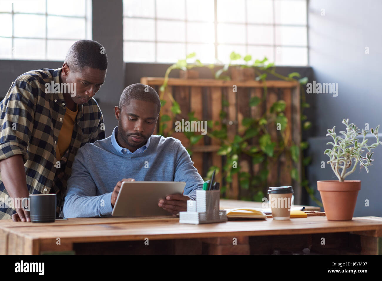 Les hommes d'affaires africains à travailler sur une tablette dans un bureau Banque D'Images