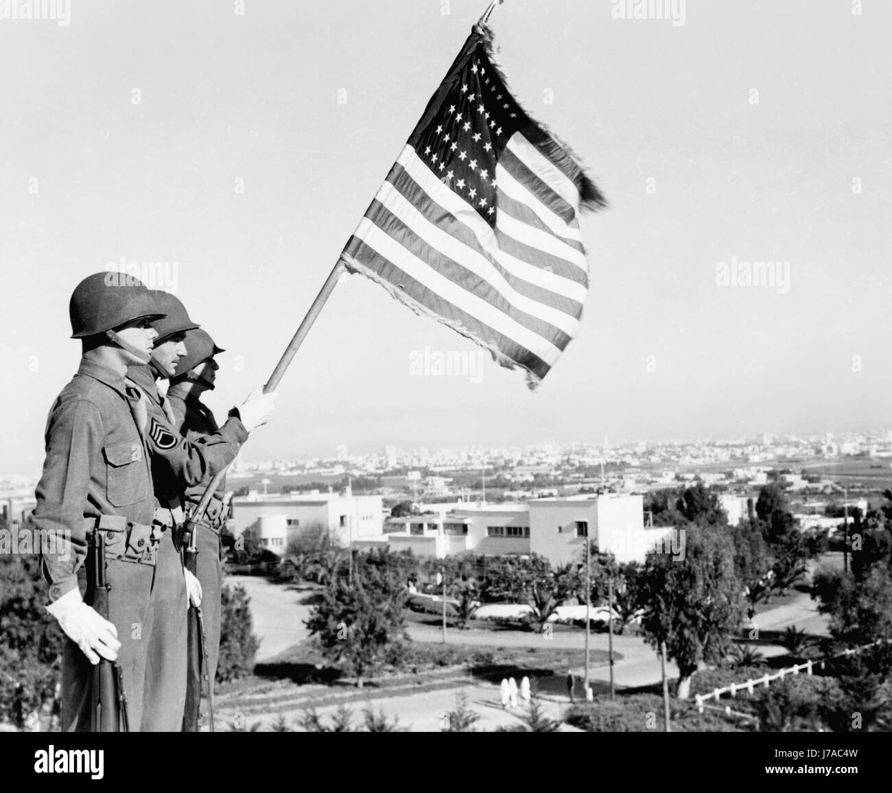 Trois soldats debout avec drapeau américain donnant sur la villa à Casablanca, Maroc, 1943. Banque D'Images