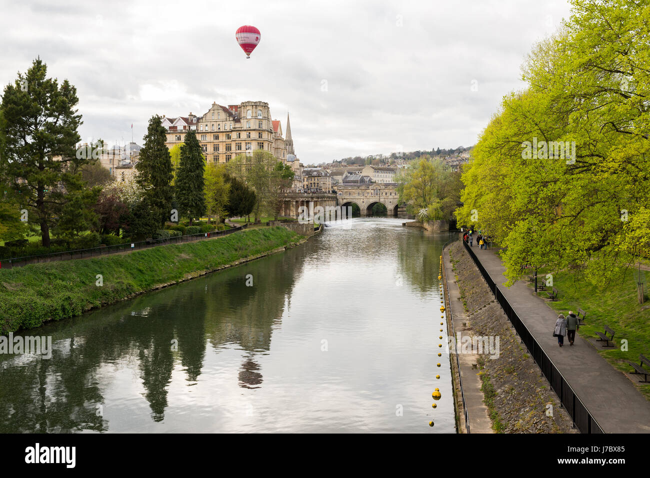 Bath, Angleterre - Avril 2017 : Pulteney Bridge traversant la rivière Avon à Bath, Angleterre, Royaume-Uni. Les gens qui marchent sur le trottoir le long de la rivière Rouge et du h Banque D'Images