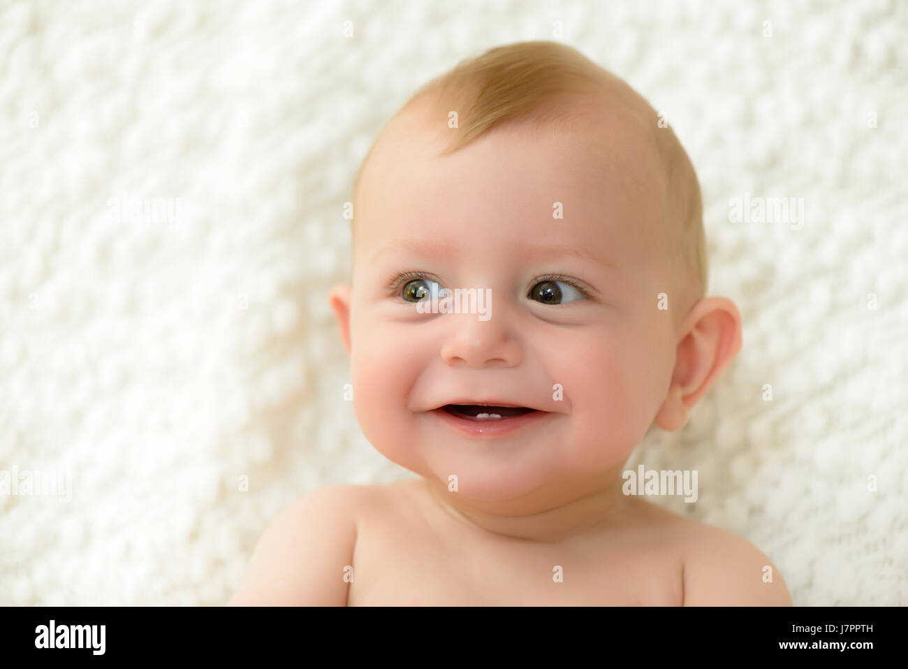 Mignon bébé riant et montrant ses premières dents Banque D'Images