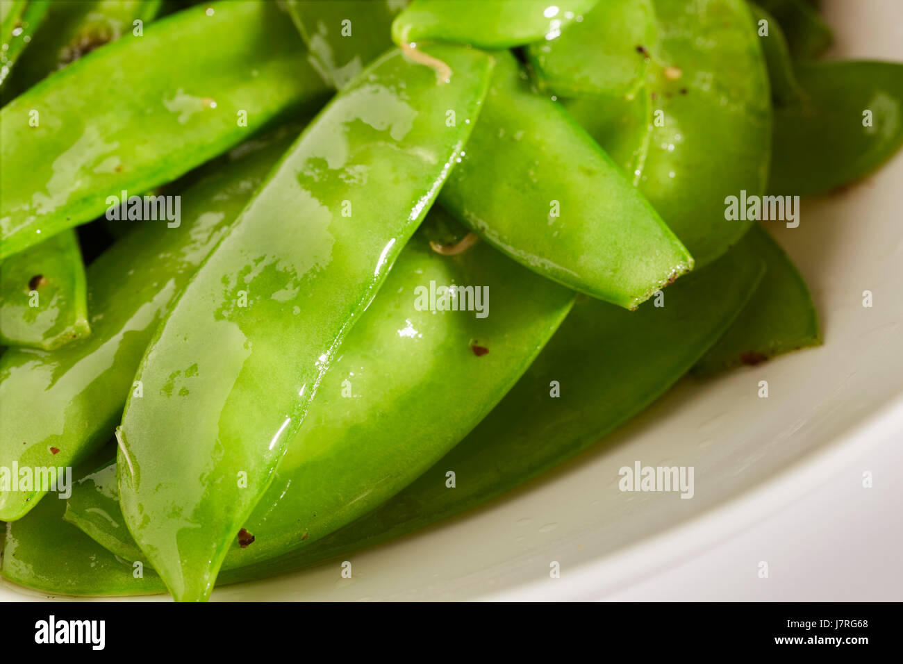 Un bol de sauté de pois gourmands Banque D'Images