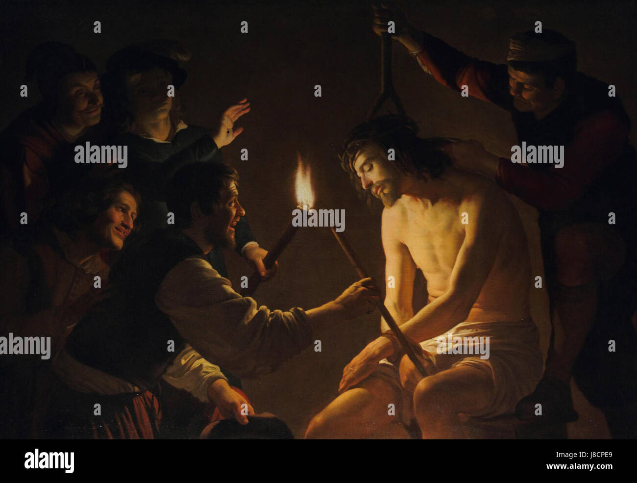 Cette peinture de Gérard van Honthorst représente la scène biblique de la moquerie du Christ, caractérisée par son utilisation du chiaroscuro et de la lumière dramatique, une technique pour laquelle Honthorst était connu dans ses œuvres baroques. Banque D'Images