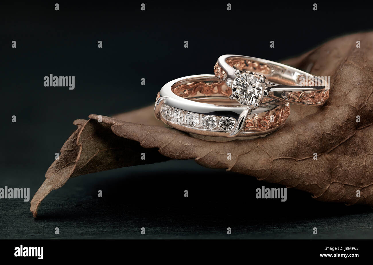 Bagues à diamant, le chevauchement des hommes et femmes, situé sur l'harmonisation de la feuille de couleur et design anneau Banque D'Images
