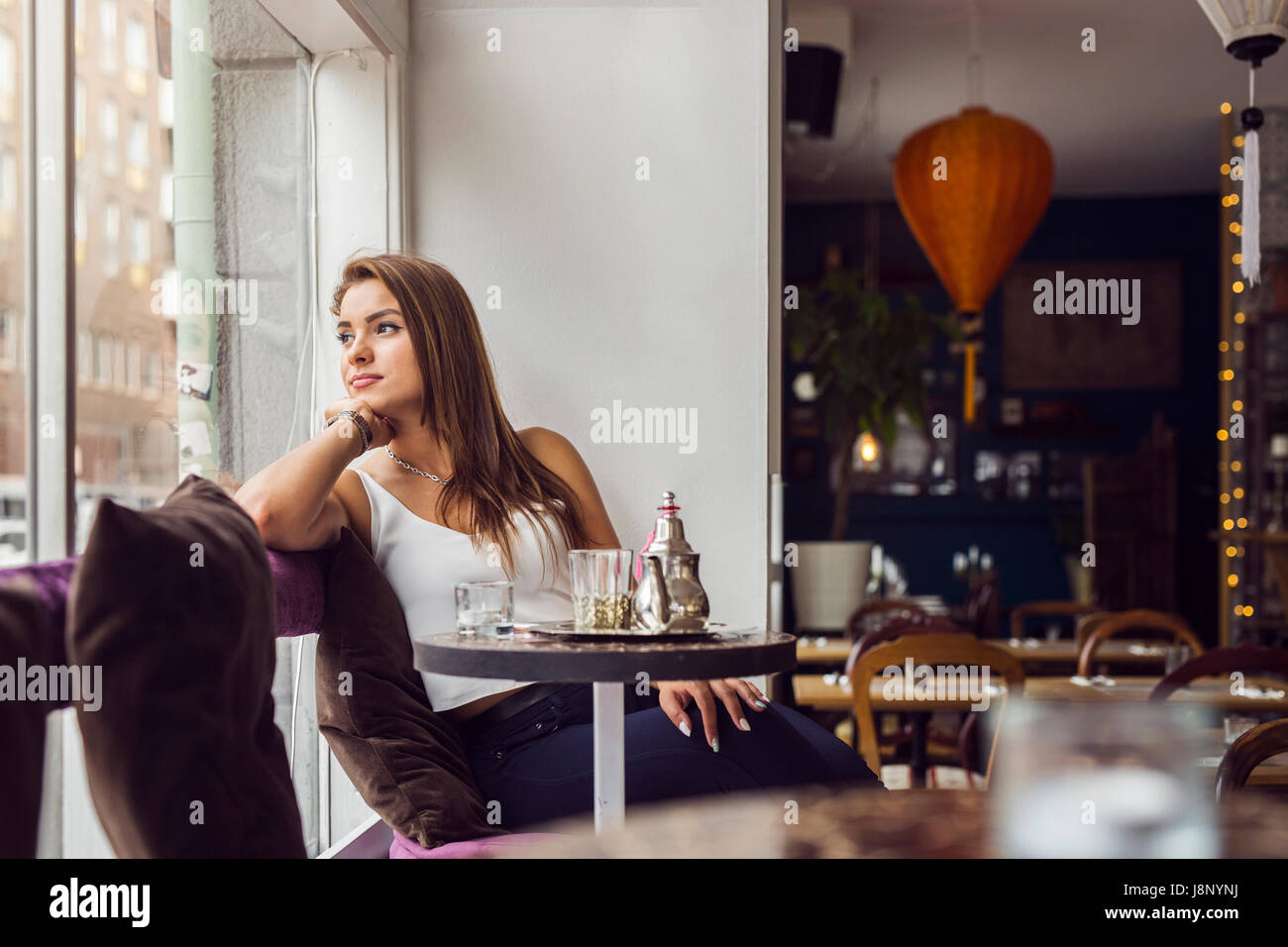 Businesswoman looking through window in restaurant Banque D'Images