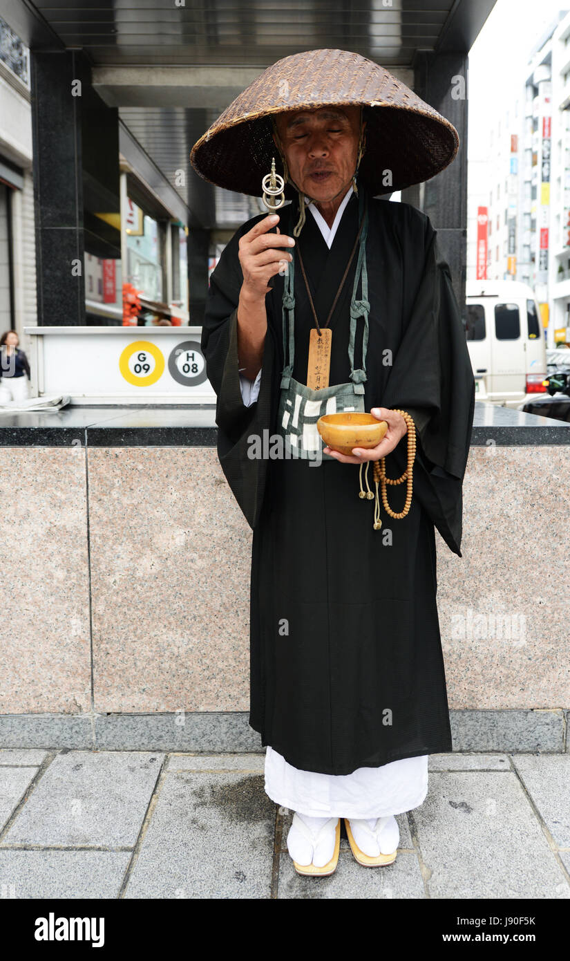 Un moine zen japonais ramassant l'aumône devant la station de métro Ginza à Tokyo, au Japon. Banque D'Images