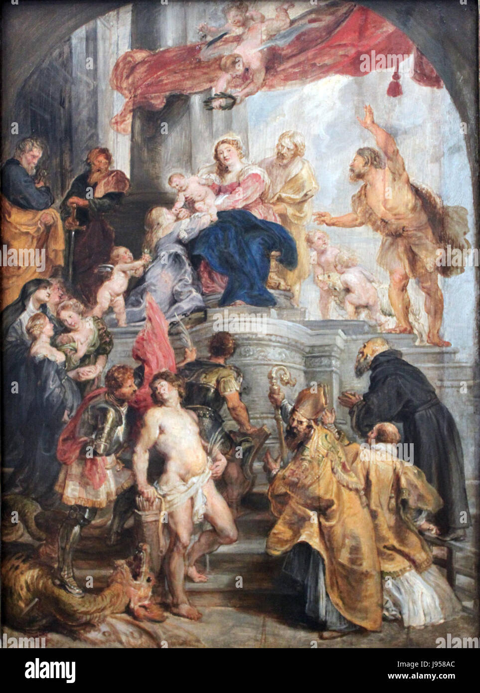 Cette peinture de Pierre Paul Rubens de 1627 représente la Vierge Marie avec l'enfant Jésus et les saints. Connu pour son style baroque, il met en valeur les thèmes religieux et l'expression émotionnelle typiques de l'œuvre de Rubens. Banque D'Images