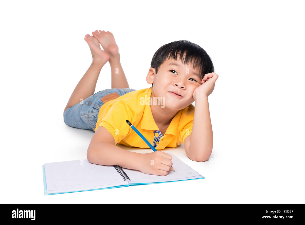 Écolier allongé sur un marbre, jusqu'à la recherche et l'écriture dans l'ordinateur portable. Banque D'Images