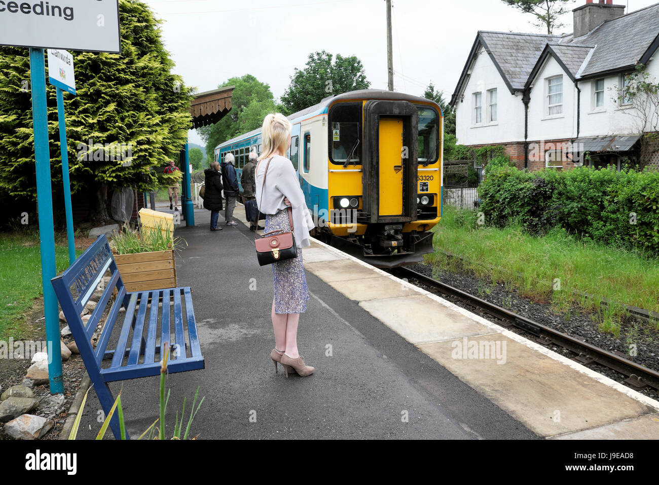 Une femme sur sa manière de travailler en attente sur la plate-forme rural pour le Cœur de la ligne de train reliant le pays de Galles arriva à Swansea au Pays de Galles UK KATHY DEWITT Banque D'Images