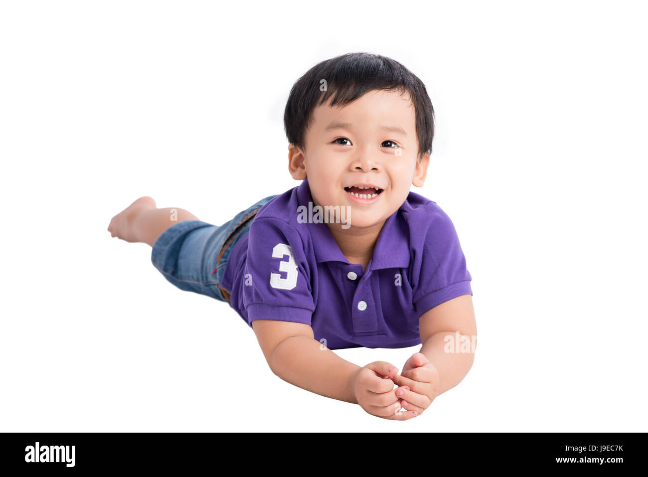 Cute asian boy lying down on white background isolated Banque D'Images