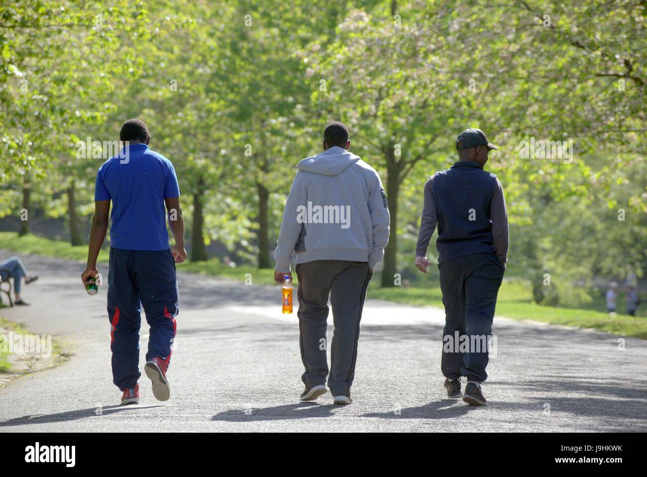 Glasgow Kelvingrove Park scenes trois hommes de race noire avec bouteille irn bru Banque D'Images