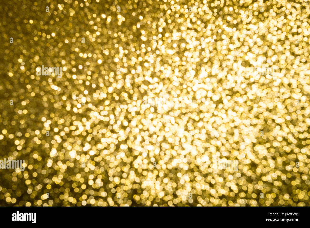 Résumé fond d'or brillant dans glitter bokeh flou artistique sous une lumière vive Banque D'Images